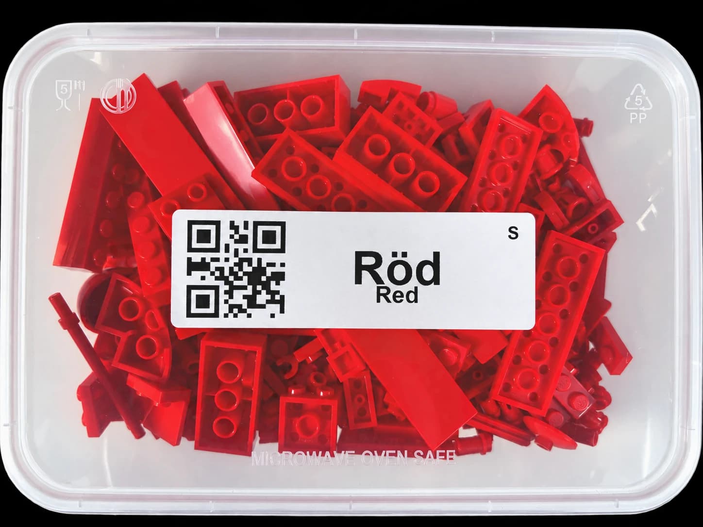 Container with red LEGO pieces and the label Red